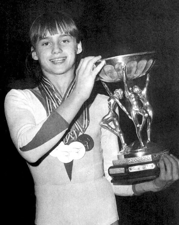 Nadia Comaneci holding a trophy